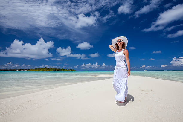istock Caucasian woman walks along beautiful seashore 489039490