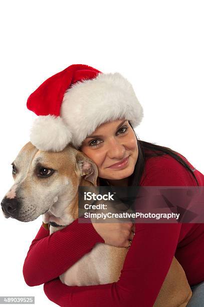 Woman In Santa Claus Hat Hugging Dog Stock Photo - Download Image Now - Adult, Adults Only, Affectionate