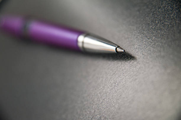 Closeup of a purple pen on a desktop