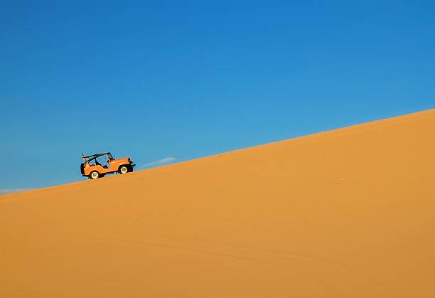 istock Four wheel drive vehicle in the sand dunes. 489040031