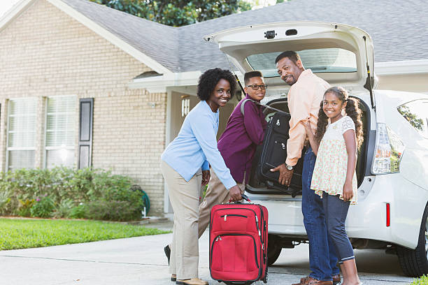 istock Family loading luggage into car going on vacation 489041392
