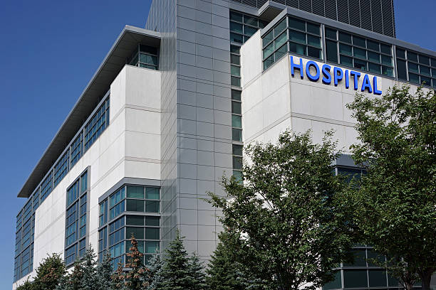 modern hospital building modern hospital building in a suburban setting surrounded by trees hospital stock pictures, royalty-free photos & images