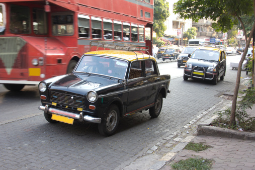 Taxis in Bombay. In the background is a typical Bombay bus