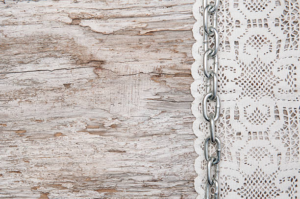 istock Lace fabric with chain on the old wood 489042969