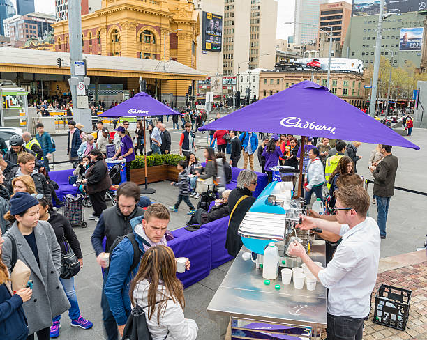 People queuing up for free coffee Melbourne, Australia - Sep 18, 2015: People queuing up for free coffee in a public promotion event at Federation Square, Melbourne cadbury plc photos stock pictures, royalty-free photos & images