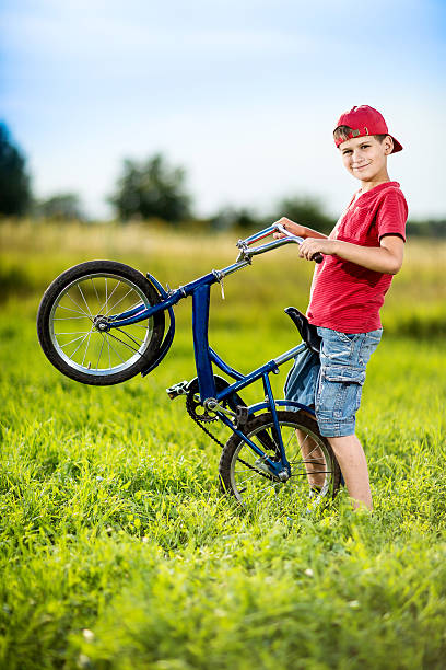 Young boy riding bicycle on a summer day