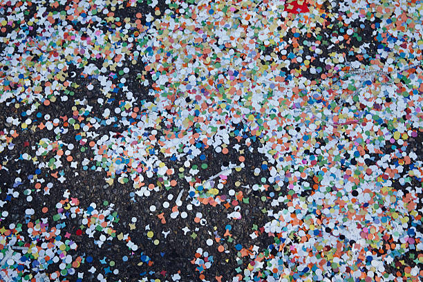 Basel (Switzerland) - Carnival 2014 Many confetti pieces are laying on the streets after the Cortege at Basel, Switzerland on March 10, 2014. fastnacht stock pictures, royalty-free photos & images