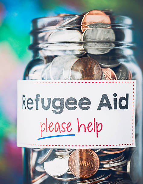 istock Refugee aid charity collection in front of world map 489075770