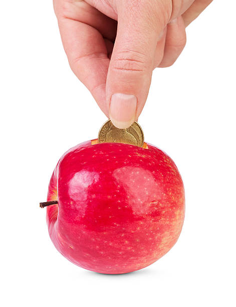 Fresh apple as piggy bank and hand with coin isolated. Concept of  healthy lifestyle investment .