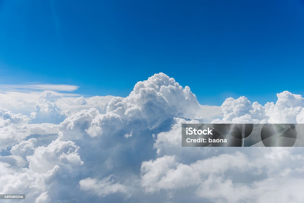 above the clouds puffy clouds and blue sky from above the clouds. Cloud - Sky Stock Photo
