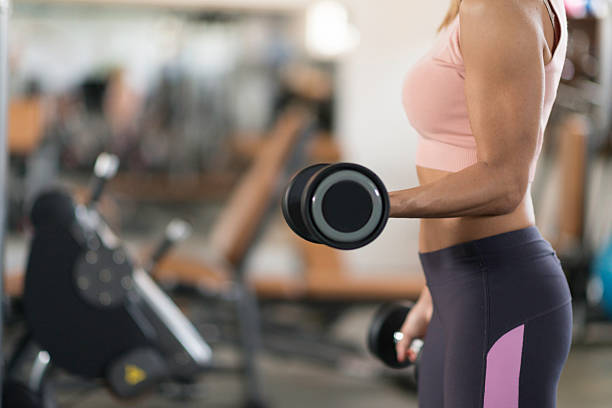 Woman exercising with weights stock photo