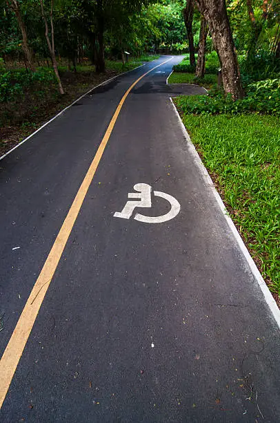 Photo of Road way cyclists and wheelchair in the garden,Thailand