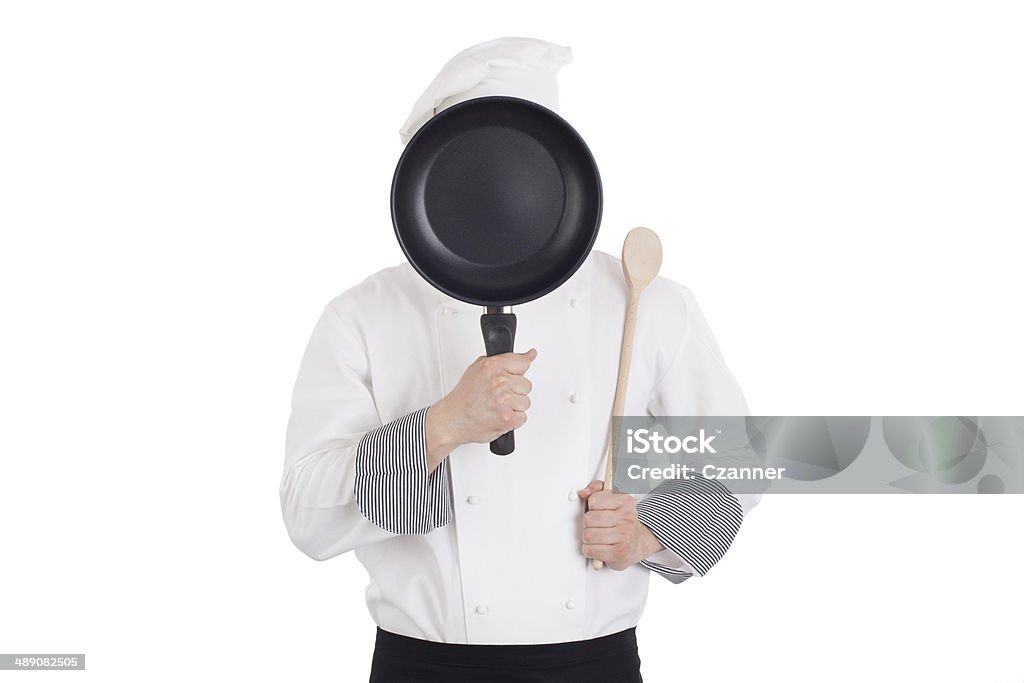 Chef behind pan Chef behind pan. Isolated on white background Adult Stock Photo