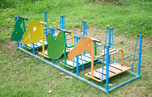 istock colorful playground swings. 489082553