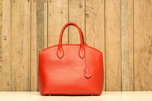 istock red purse on wood background 489083263