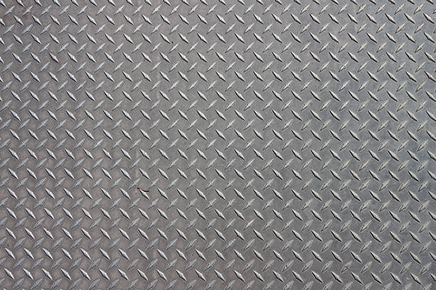 Metal Pattern A diagonal pattern on gray metal floor plate stock pictures, royalty-free photos & images