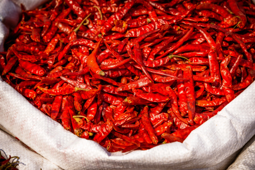 Drying red chili pepper at the Chadni Chowk spice market in Delhi, India 