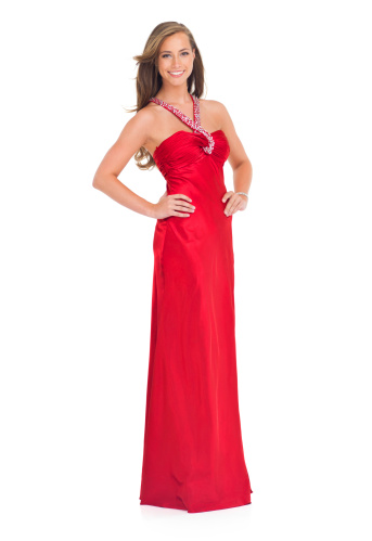 Studio shot of a stylish young woman in a red dress isolated on white