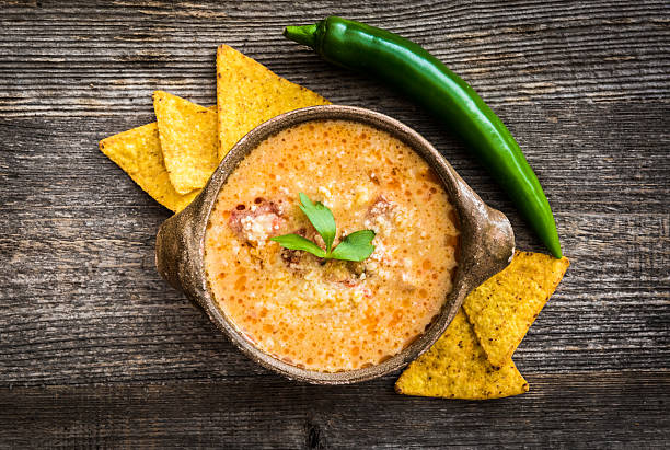 istock Sope queso with vegetables on wooden background 489086666