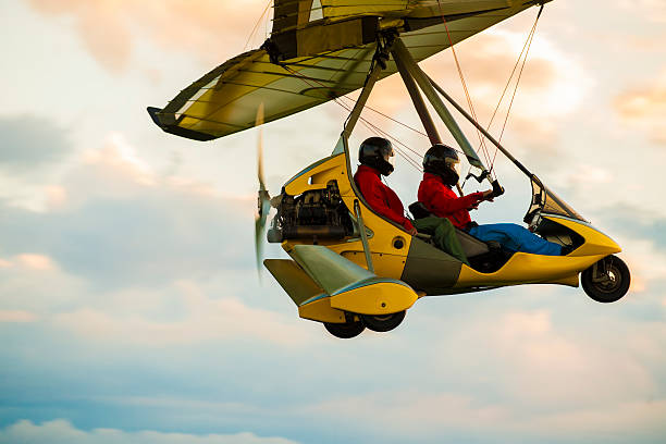 Microlight aircraft in the air Microlight aircraft in the air flying in sunset ultralight photos stock pictures, royalty-free photos & images