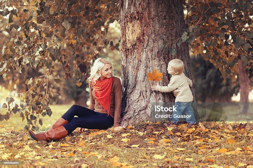 Family in autumn park! Mom playing with son child Autumn Stock Photo