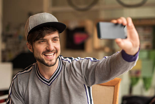 istock Young happy hipster man taking a selfie with cell phone. 489087122