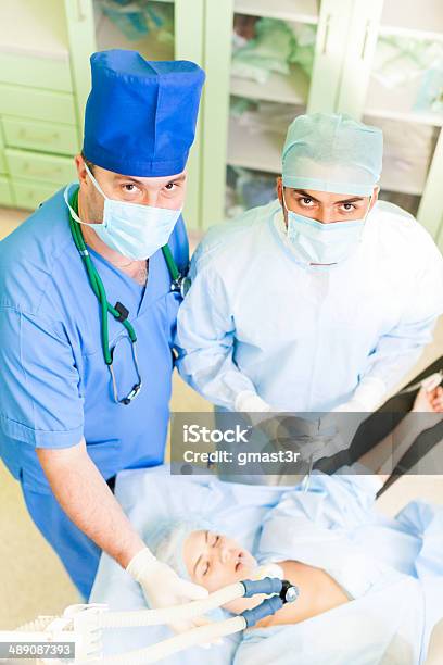 Surgery Team Operating In A Surgical Room Stock Photo - Download Image Now - Accidents and Disasters, Adult, Anesthesiologist