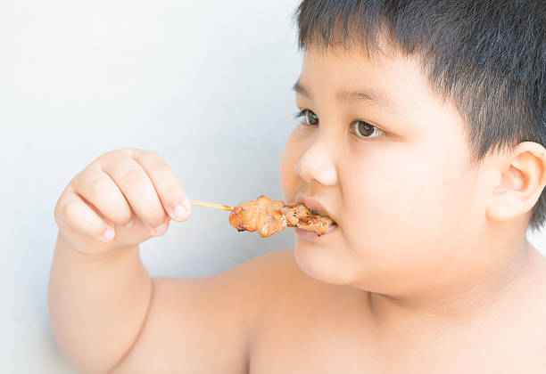 Fat boy eat grilled pork