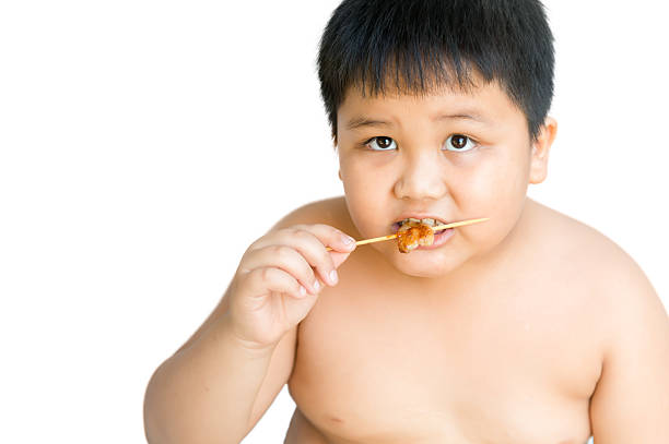 istock Fat boy eat grilled pork isolated 489087730