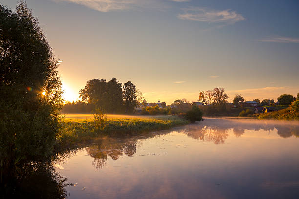 istock Foggy river with grass in the morning sunlight 489089308