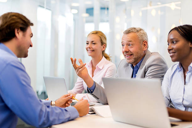 istock Smiling business team interviewing a man for new staff member. 489090754