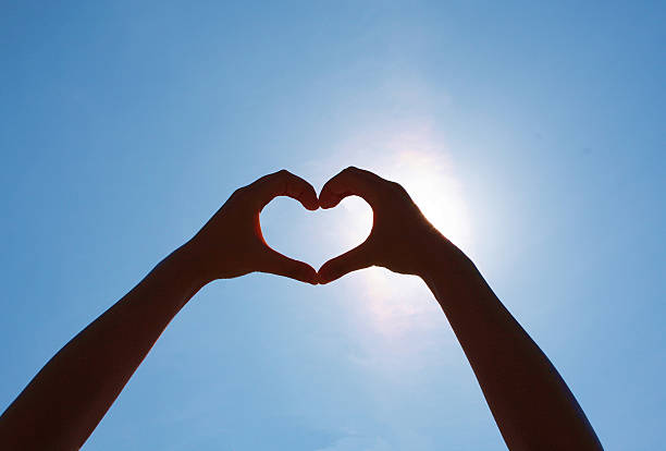 istock Girls heart hands on the sky 489090774