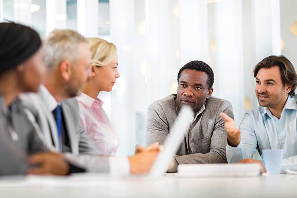 istock Smiling business colleagues talking during a meeting in the office. 489090806