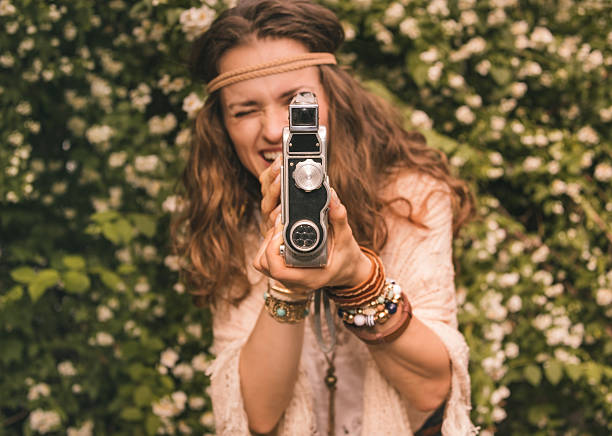 istock closeup on bohemian young woman among flowers using retro camera 489091146
