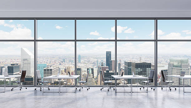 istock Workplaces in a modern panoramic office, New York city view 489110230
