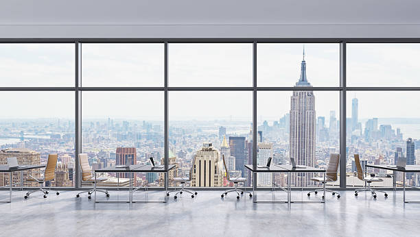 istock Workplaces in a modern panoramic office, New York city view 489110244