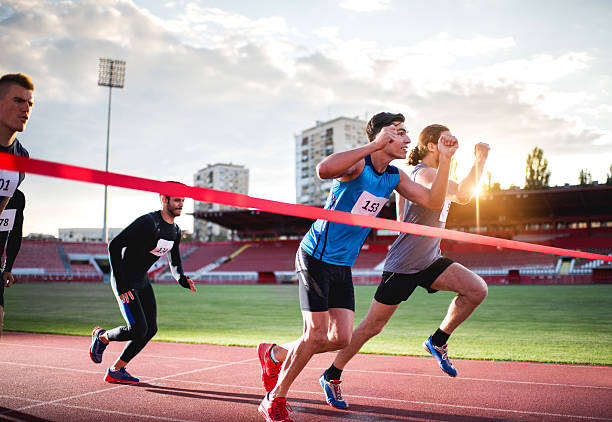 istock Athletic men about to cross the finish line . 489110336