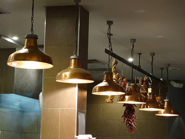 istock Image of copper hanging lamps / lights in row, restaurant kitchen 489112026