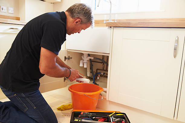istock Male plumber preparing a pipe for the sink in kitchen 489112262