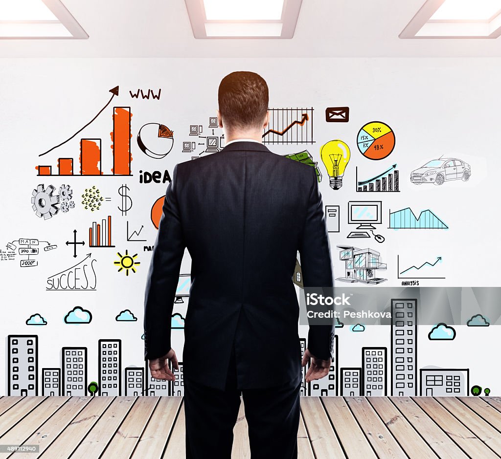 business concept on  wall young businessman looking to drawing business concept on  wall 2015 Stock Photo