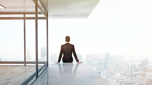 istock businessman sitting on skyscrapper 489113092
