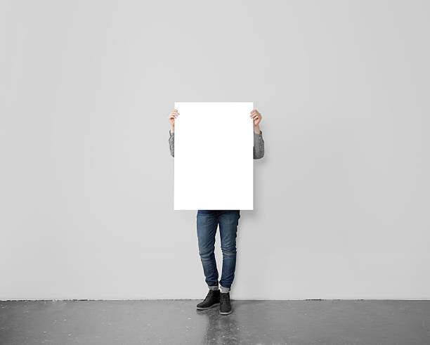 istock hipster holding blank poster 489113332