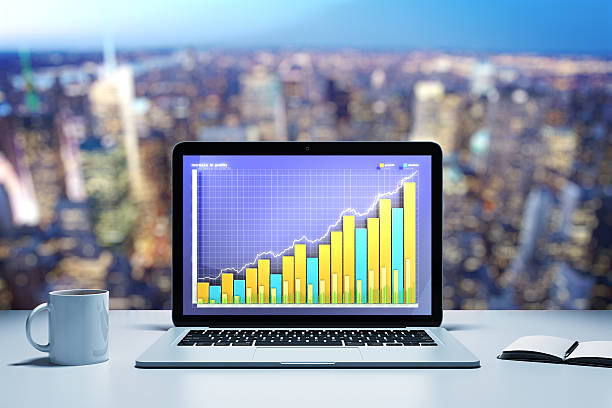 istock Laptop with business graph on a table in evening office 489114008