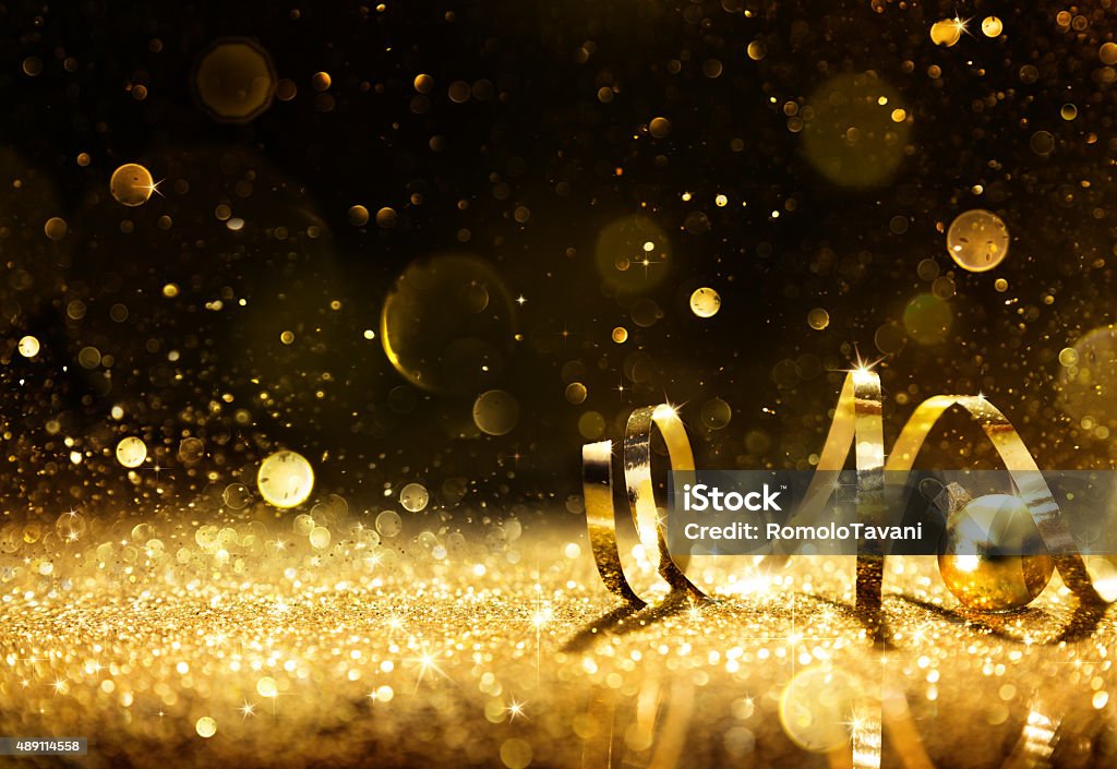 Golden streamers with sparkling glitter Golden ribbon on shining glitter - christmas background Backgrounds Stock Photo