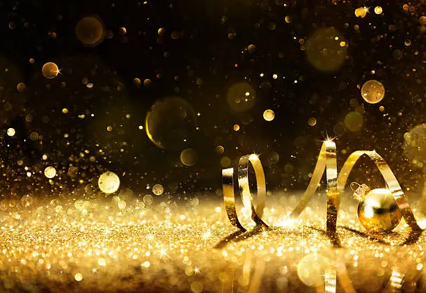 Photo of Golden streamers with sparkling glitter