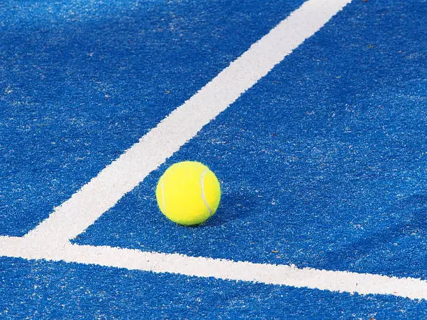 Photo of Single Tennis ball blue artificial grass court with lines