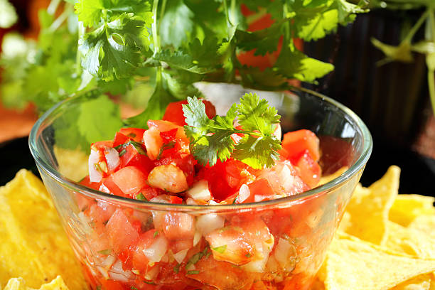 istock Mexican pico de gallo salsa with nachos and coriander 489115104