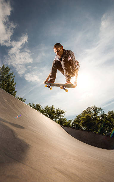 istock Young skateboarder practicing Ollie on a skate ramp. 489115408