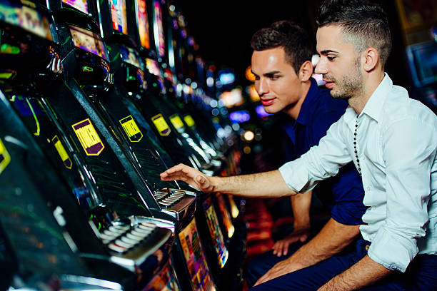 Playing Slot Machines Stock Photo - Download Image Now - Slot Machine,  Casino, Gambling - iStock