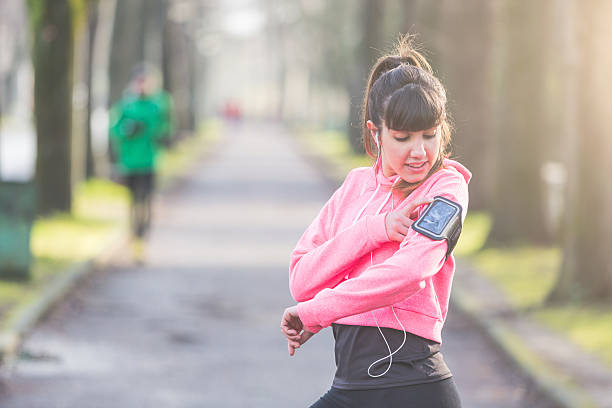 istock Young sporty woman checking smart phone during workout 489117660